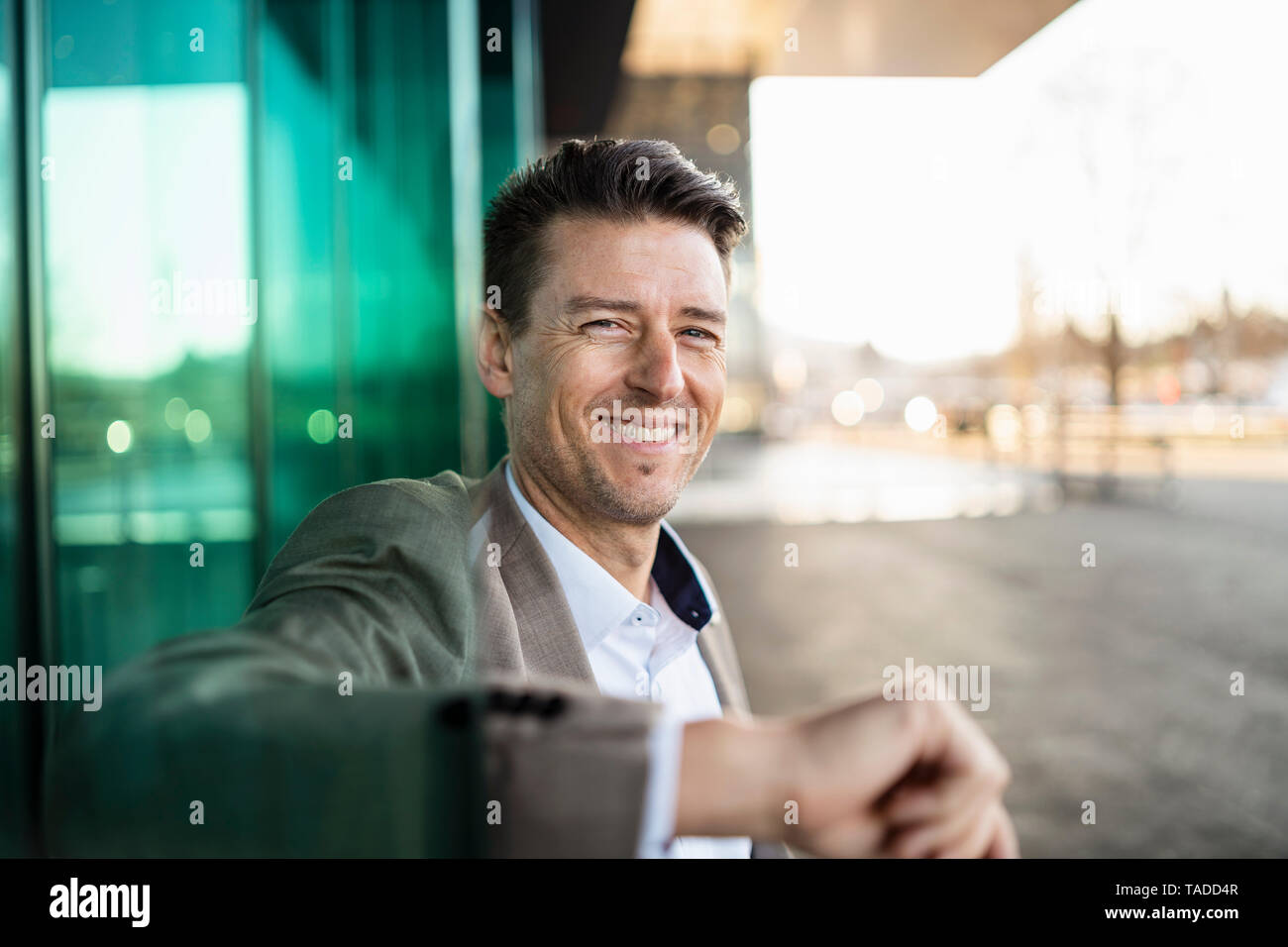 Portrait of smiling businessman à l'extérieur d'un bâtiment de la ville Banque D'Images