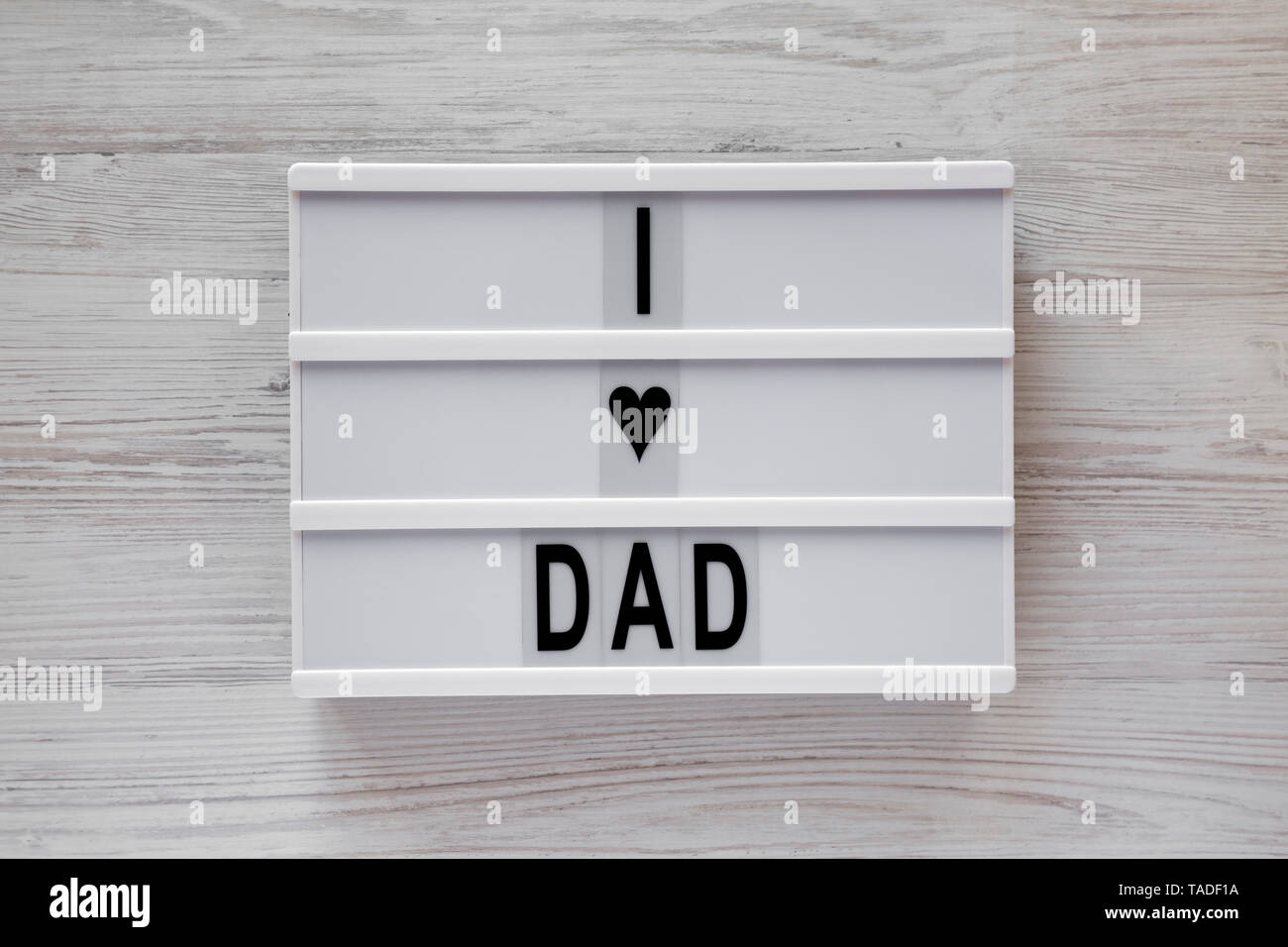 "J'aime papa" mots sur une lightbox sur fond de bois blanc, vue du dessus. Les frais généraux, de dessus, de mise à plat. Banque D'Images