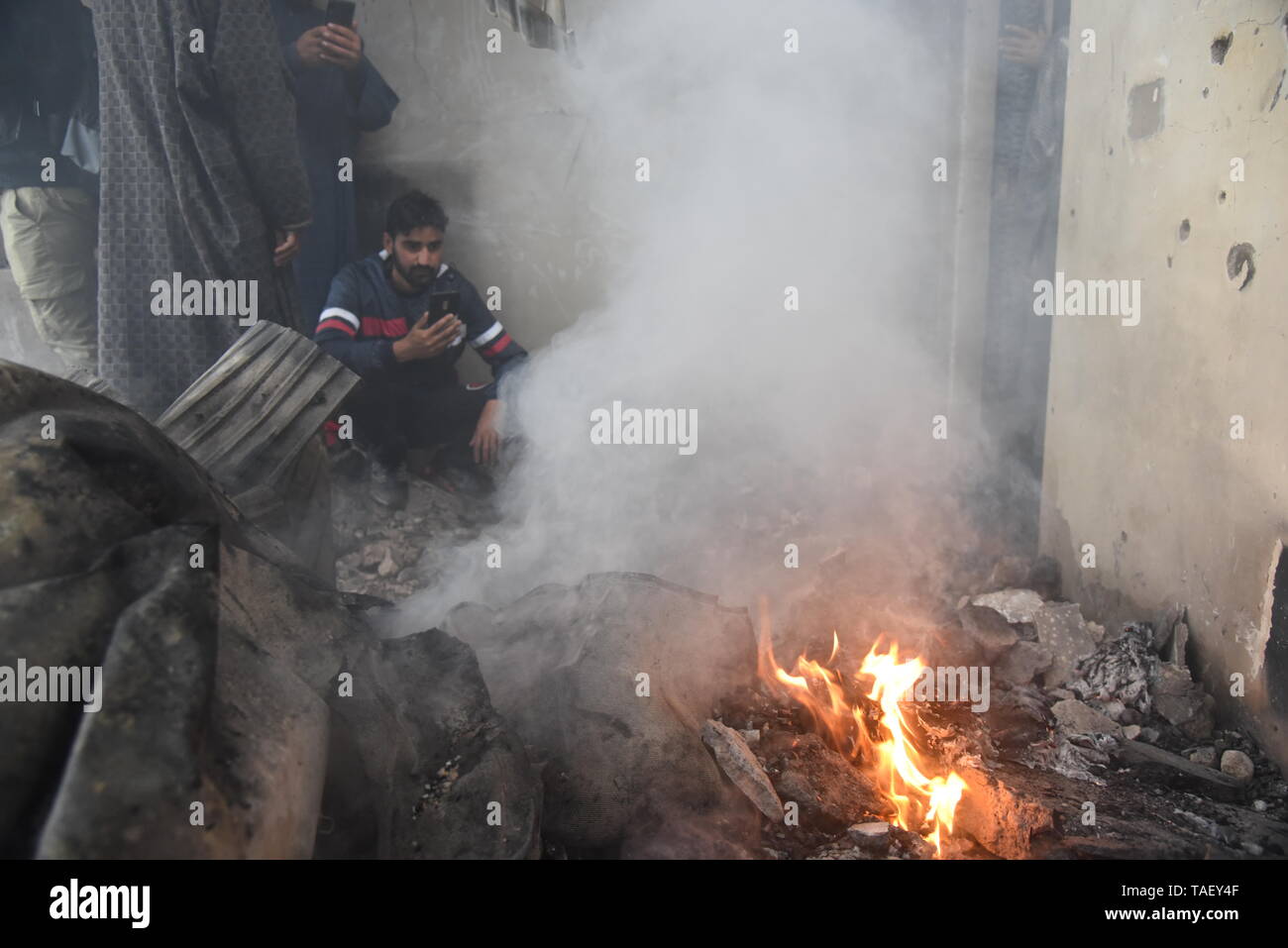 Les villageois du Cachemire sont vu l'inspection de maison ravagé par la guerre après une fusillade dans la région de Pulwama, au sud de Srinagar. Zakir Rashid Bhat Musa Alias a été tué jeudi par les forces de sécurité dans le district de Pulwama lorsque les forces de sécurité ont lancé une opération de bouclage et de ratissage dans Dadsara village de la zone centrale, au sud de Srinagar à la suite d'informations sur la présence de militants. Banque D'Images