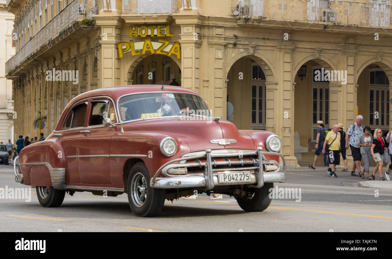 La Havane, Cuba - Un taxi passe en face de l'hôtel Plaza près de Parque Central. Classic voitures américaines des années 50, importées avant l'embargo américain, sont Banque D'Images