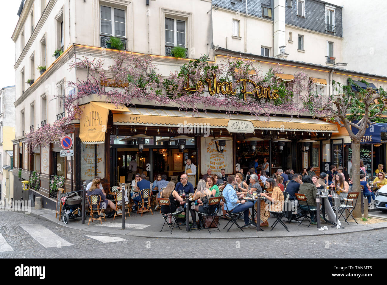 Les gens assis dehors sur la terrasse du café Le vrai Paris Banque D'Images
