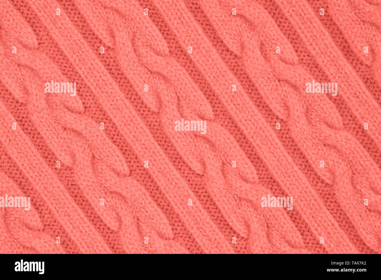 De couleur corail très tendance Tissu Tricot Texture avec des Tresses et de rayures. Tricot Machine répéter la texture de chandail. En arrière-plan. La diagonale Banque D'Images