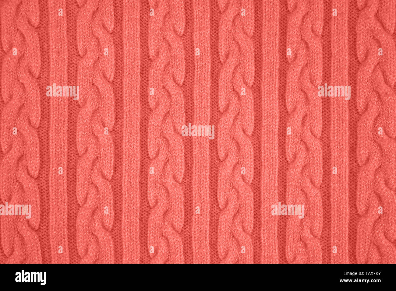 De couleur corail très tendance Tissu Tricot Texture avec des Tresses et de rayures. Tricot Machine répéter la texture de chandail. En arrière-plan. Couleur de th Banque D'Images