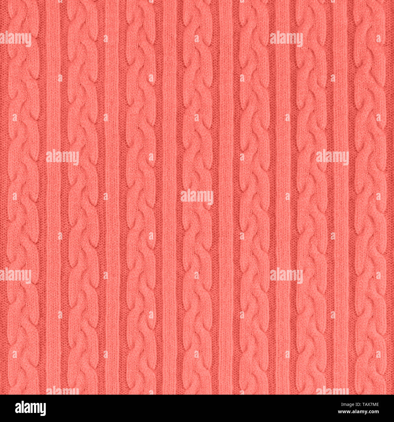 De couleur corail très tendance Tissu Tricot Texture avec des Tresses et de rayures. Tricot Machine répéter la texture de chandail. En arrière-plan. Couleur de th Banque D'Images