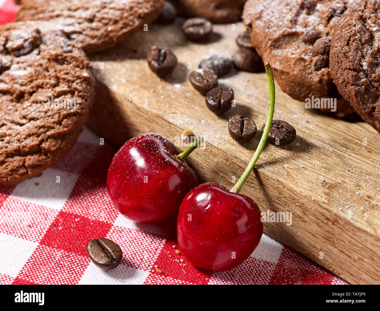Les cookies au chocolat à l'avoine avec des grains de café et de cerise. Serveur Sun flare Banque D'Images