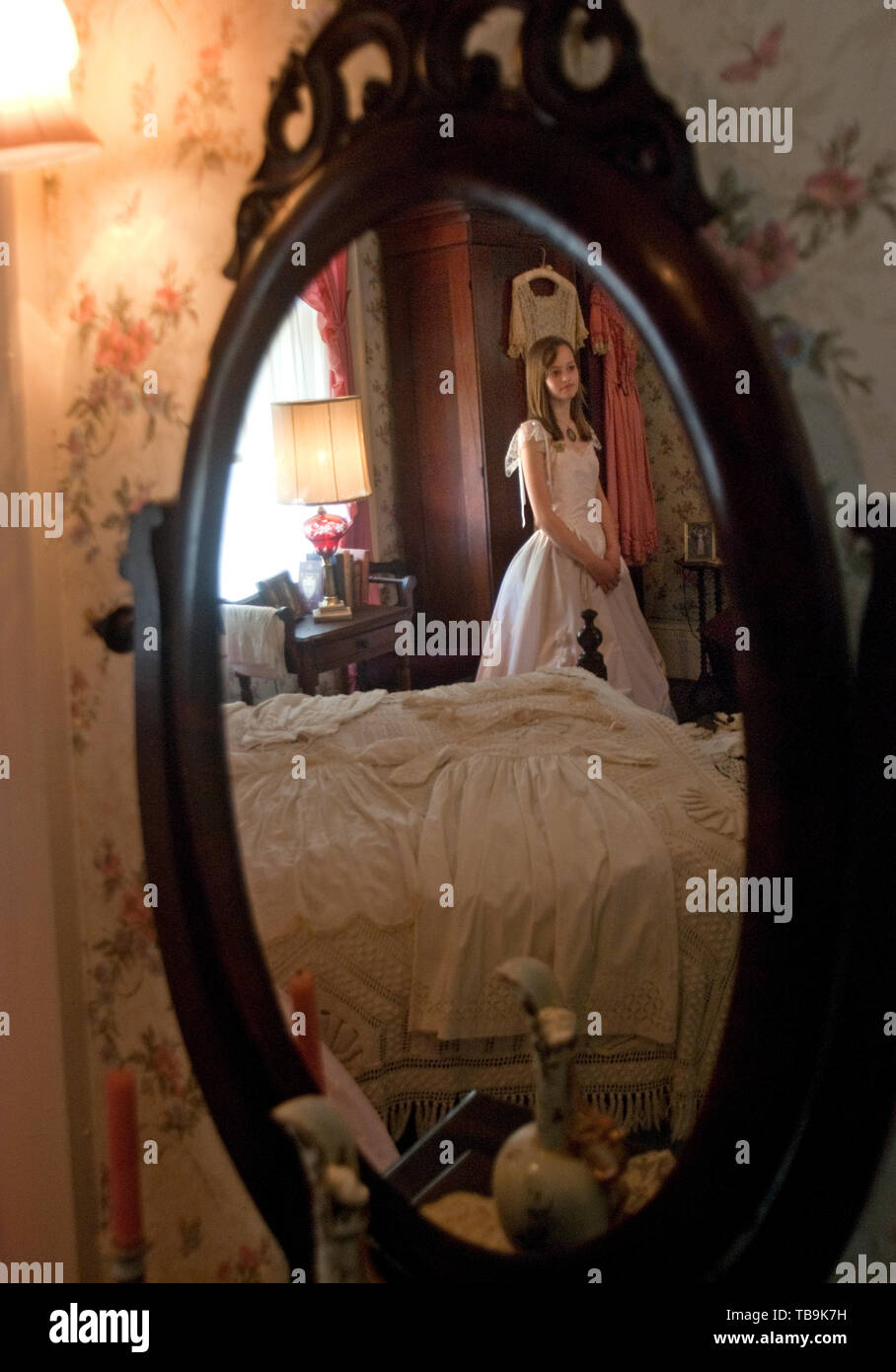 Une fille dans une robe d'avant se reflète dans un miroir à l'Amtsi Love Home à Columbus, Mississippi, le 17 avril 2010. Banque D'Images