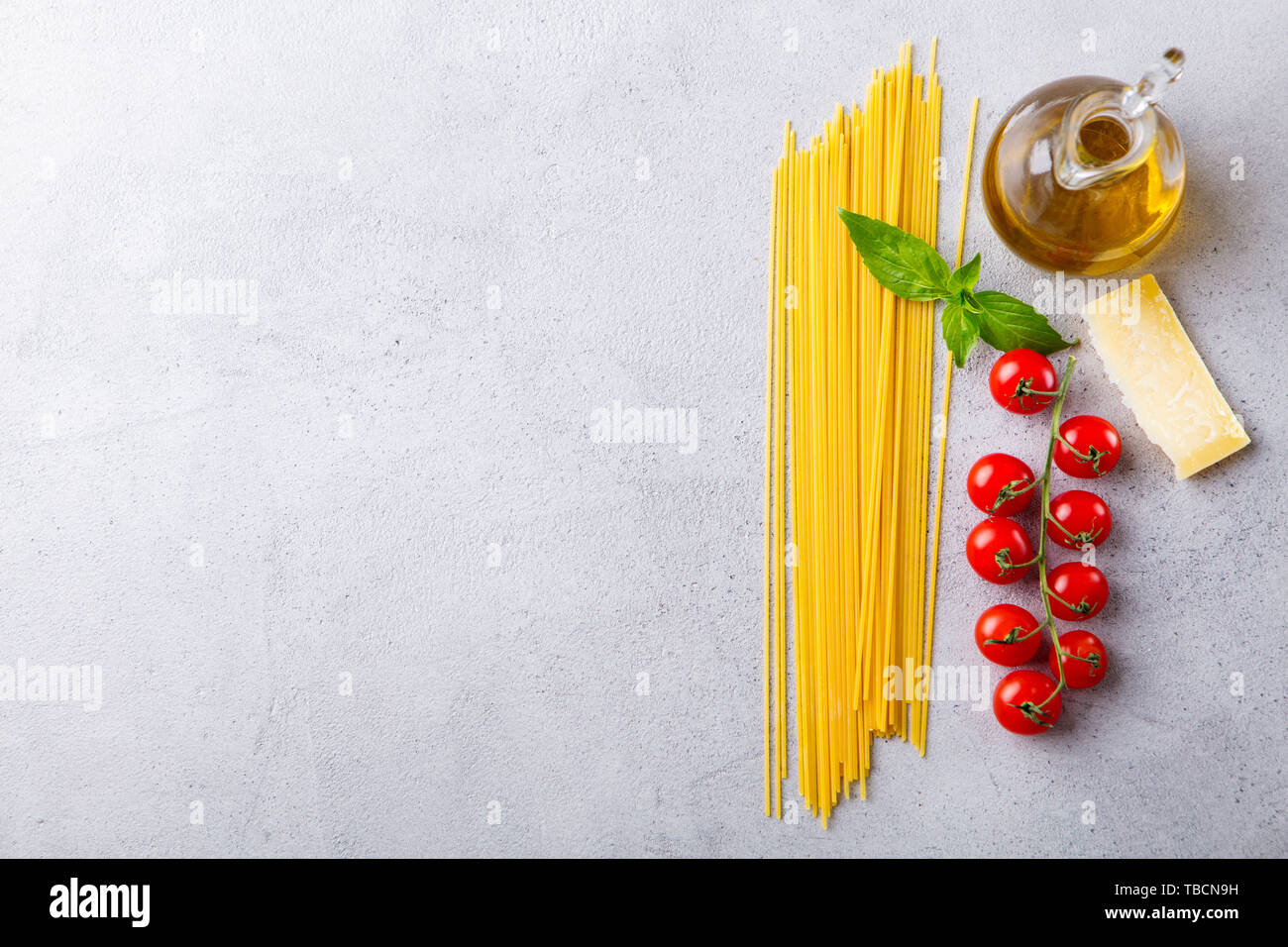 Ingrédients pour la cuisson des pâtes spaghetti. Vue d'en haut. Copier l'espace. Fond gris. Banque D'Images