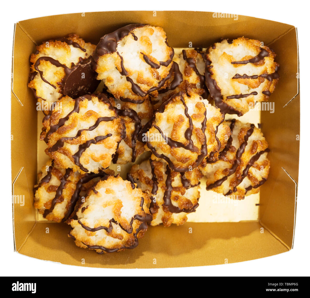 Macarons noix de coco au lustre de chocolat dans un emballage en carton. Au four dessert délicat. Plus isolé sur fond blanc Banque D'Images