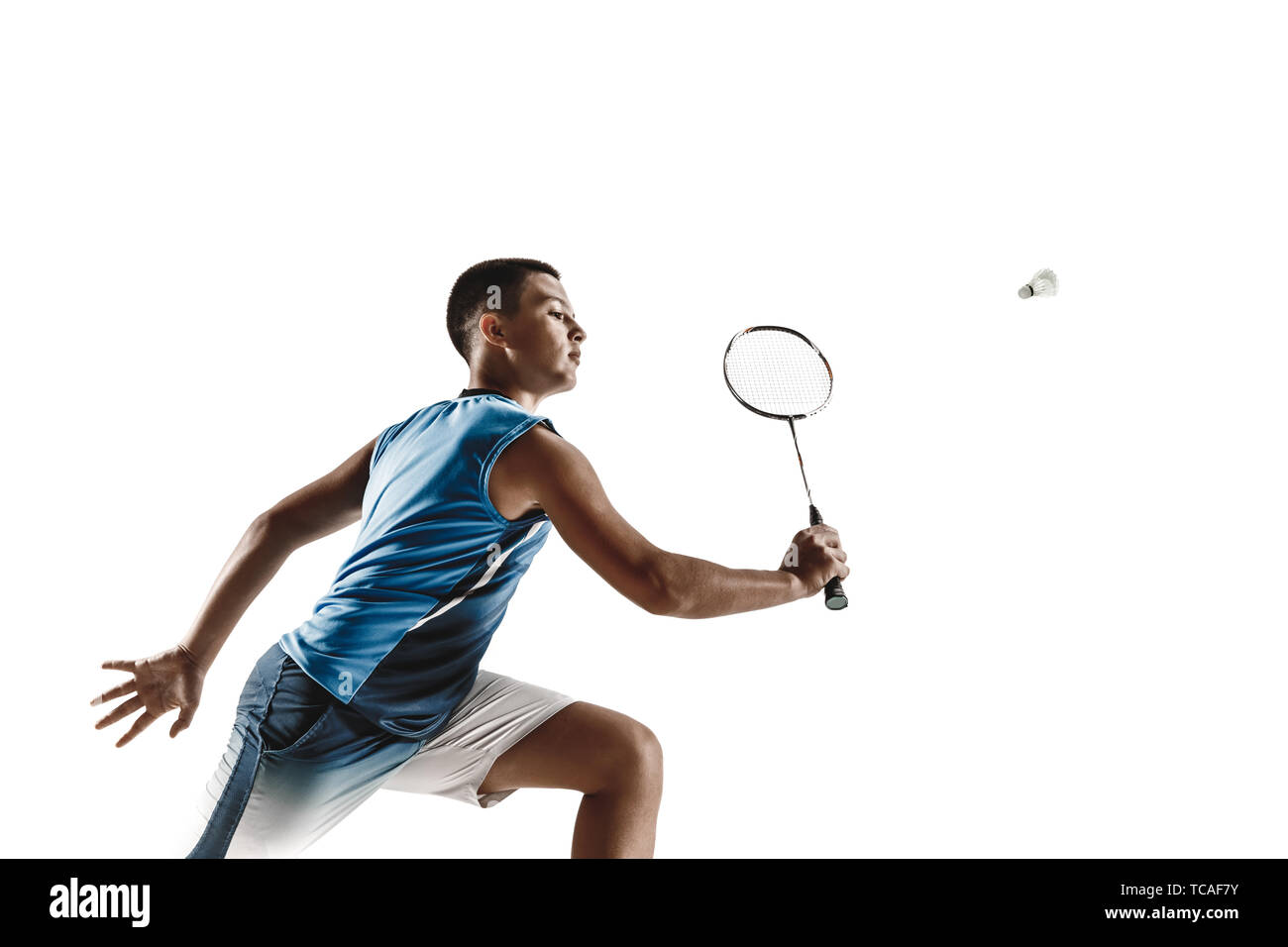 Petit garçon jouer au badminton isolated on white background studio. Jeune  modèle masculin en sportwear et chaussures avec la raquette en action,  mouvement dans le jeu. Concept de mouvement, sport, mode de