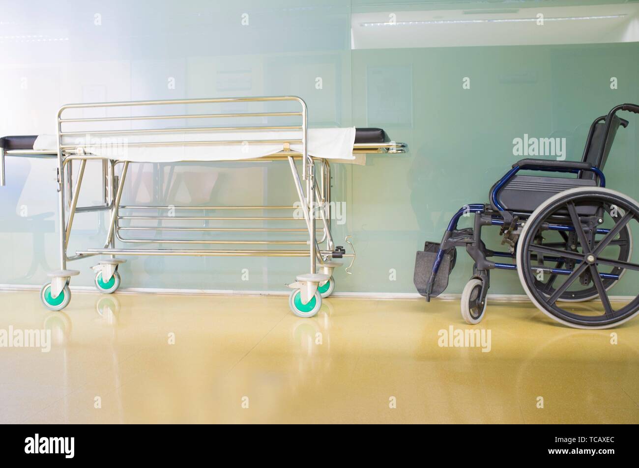 Centre de soins de l'intérieur de couloir. L'environnement moderne et rutilante avec brancard et fauteuil roulant. Banque D'Images
