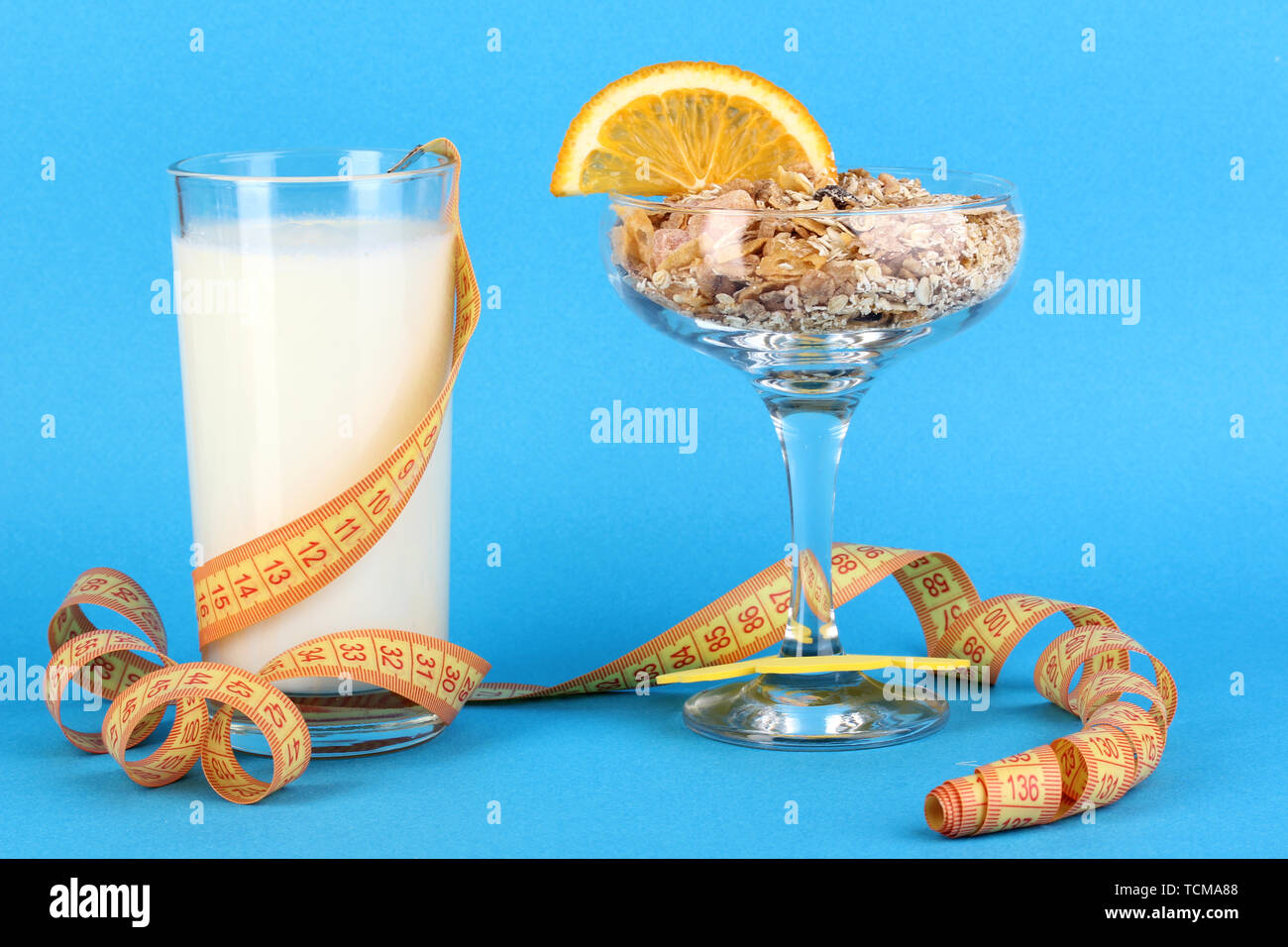 Poumons en vase pour desserts muesli et lait en verre sur fond bleu Banque D'Images