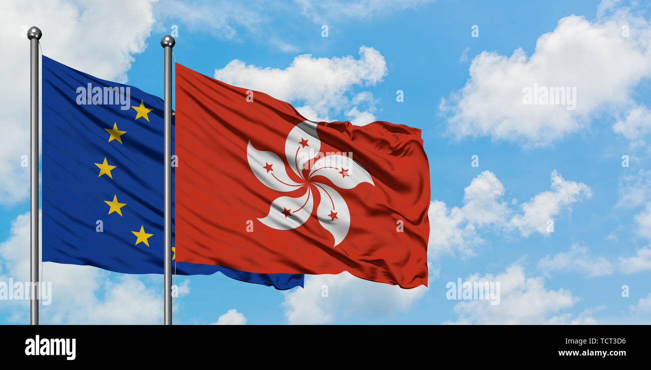 L'Union européenne et Hong Kong drapeaux dans le vent contre ciel bleu nuageux blanc ensemble. Concept de diplomatie, de relations internationales. Banque D'Images
