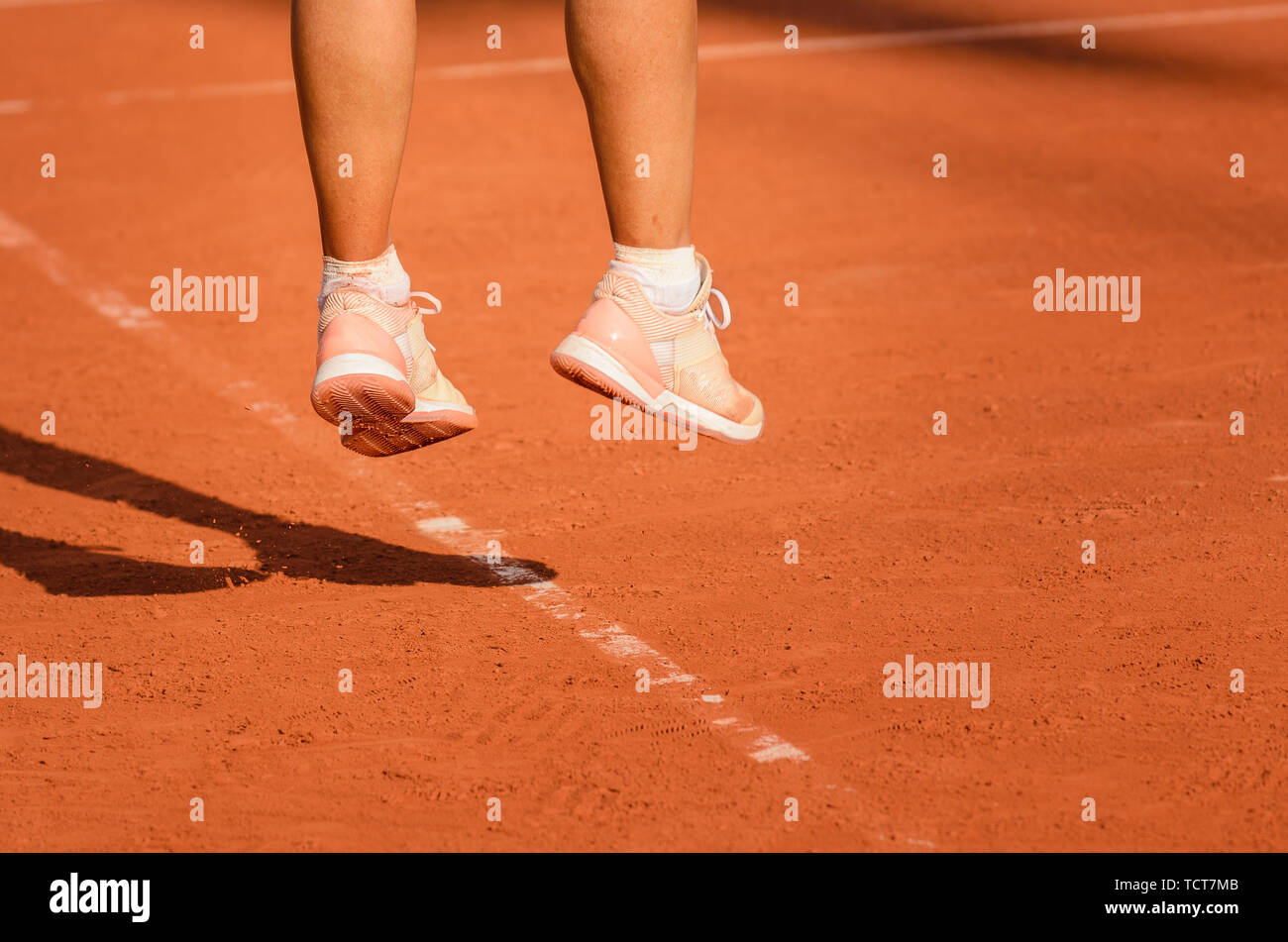 Pieds d'un joueur de tennis féminin dans les sauts après avoir tourné, le service Banque D'Images