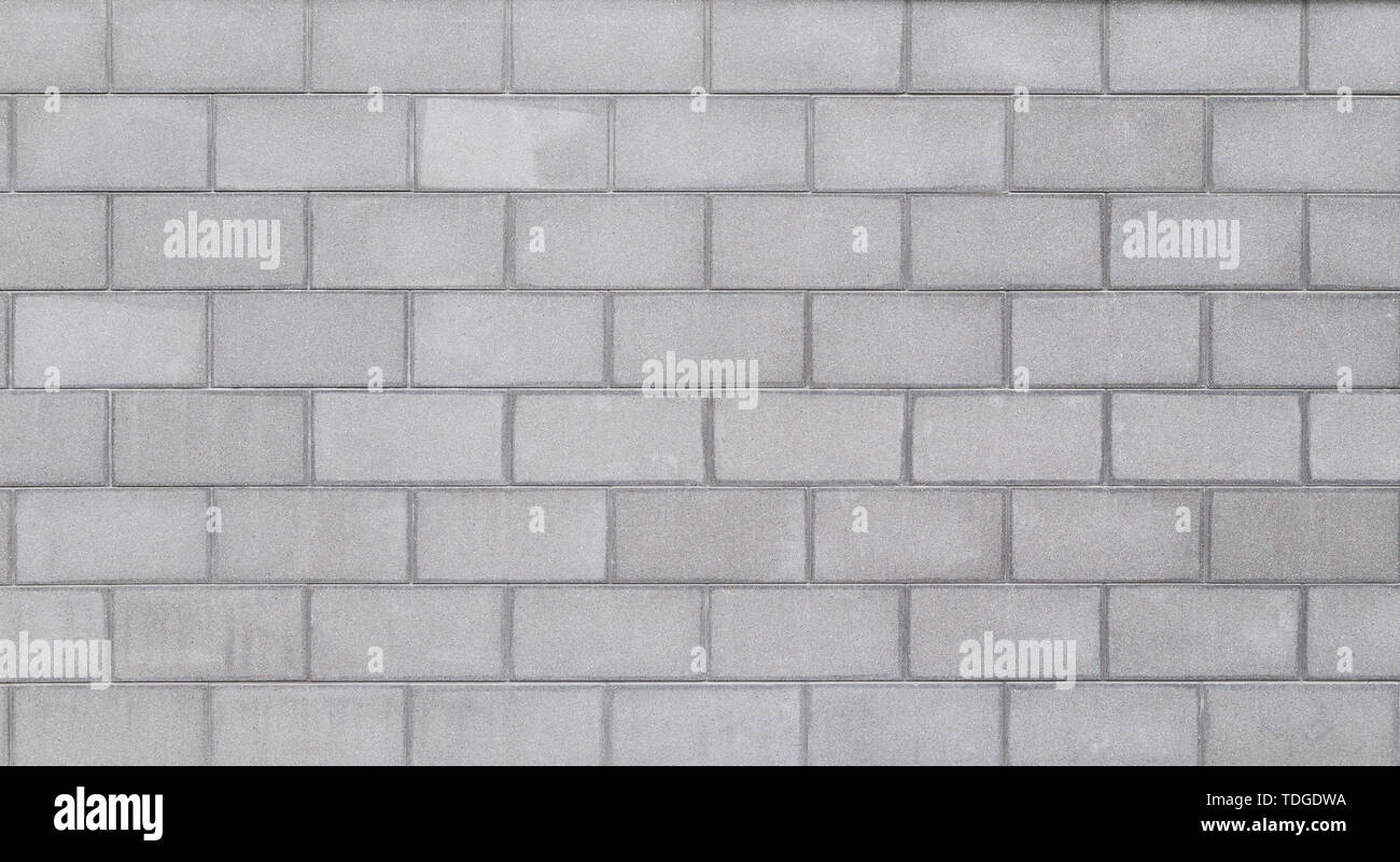 La haute résolution full frame background d'un mur ou d'un extérieur de l'immeuble faite de blocs de béton gris clair. Copier l'espace. Banque D'Images