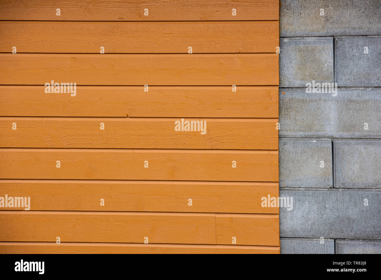 Mur avec une partie des blocs de ciment, panneaux de bois jaune partie. Banque D'Images