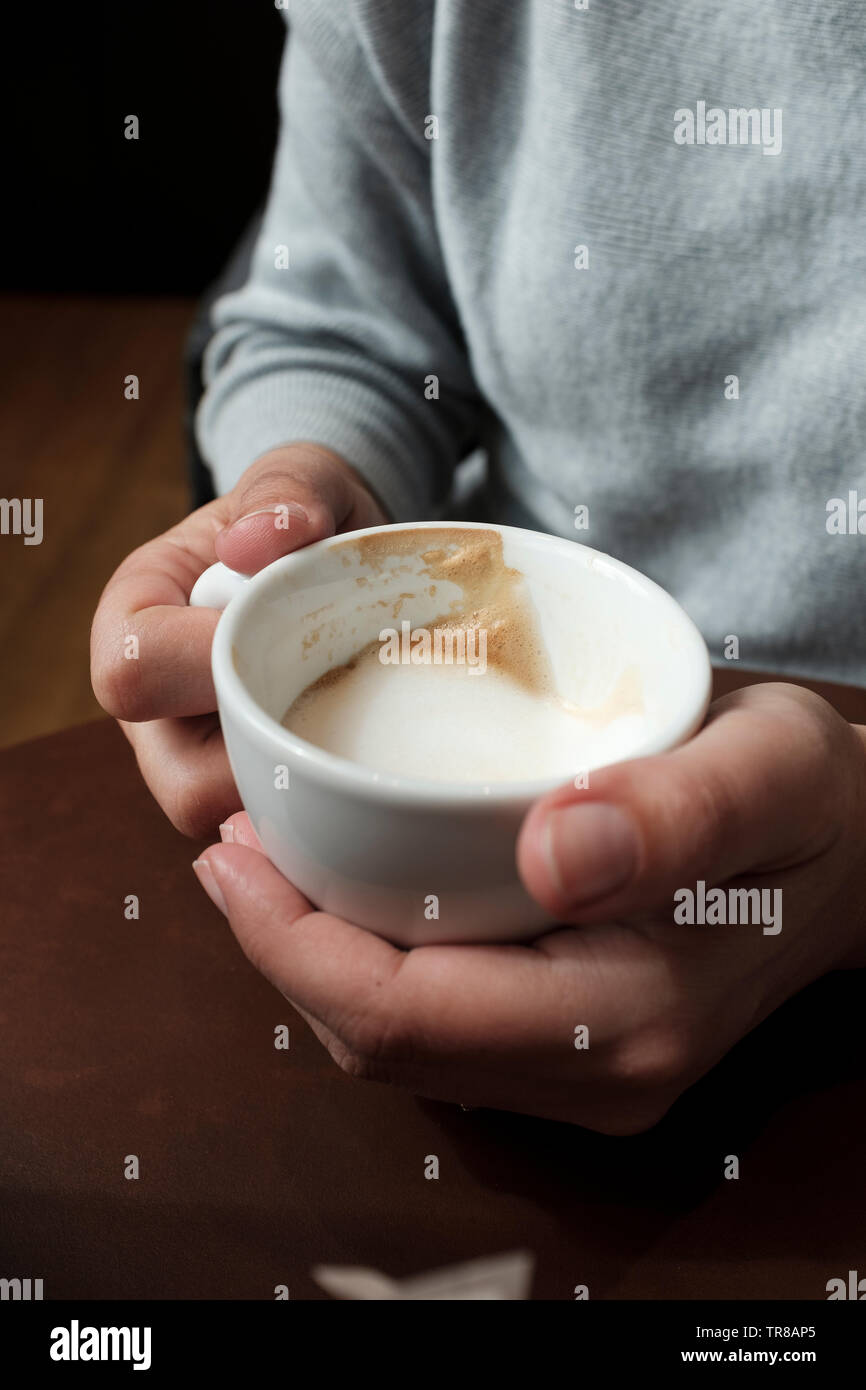 Femme avec un cappuccino en mains-close-up Banque D'Images