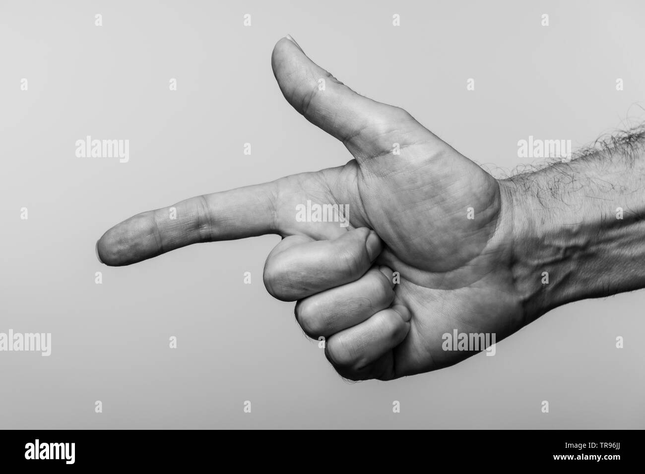 Close up of a mans hand pointing, noir et blanc. Banque D'Images