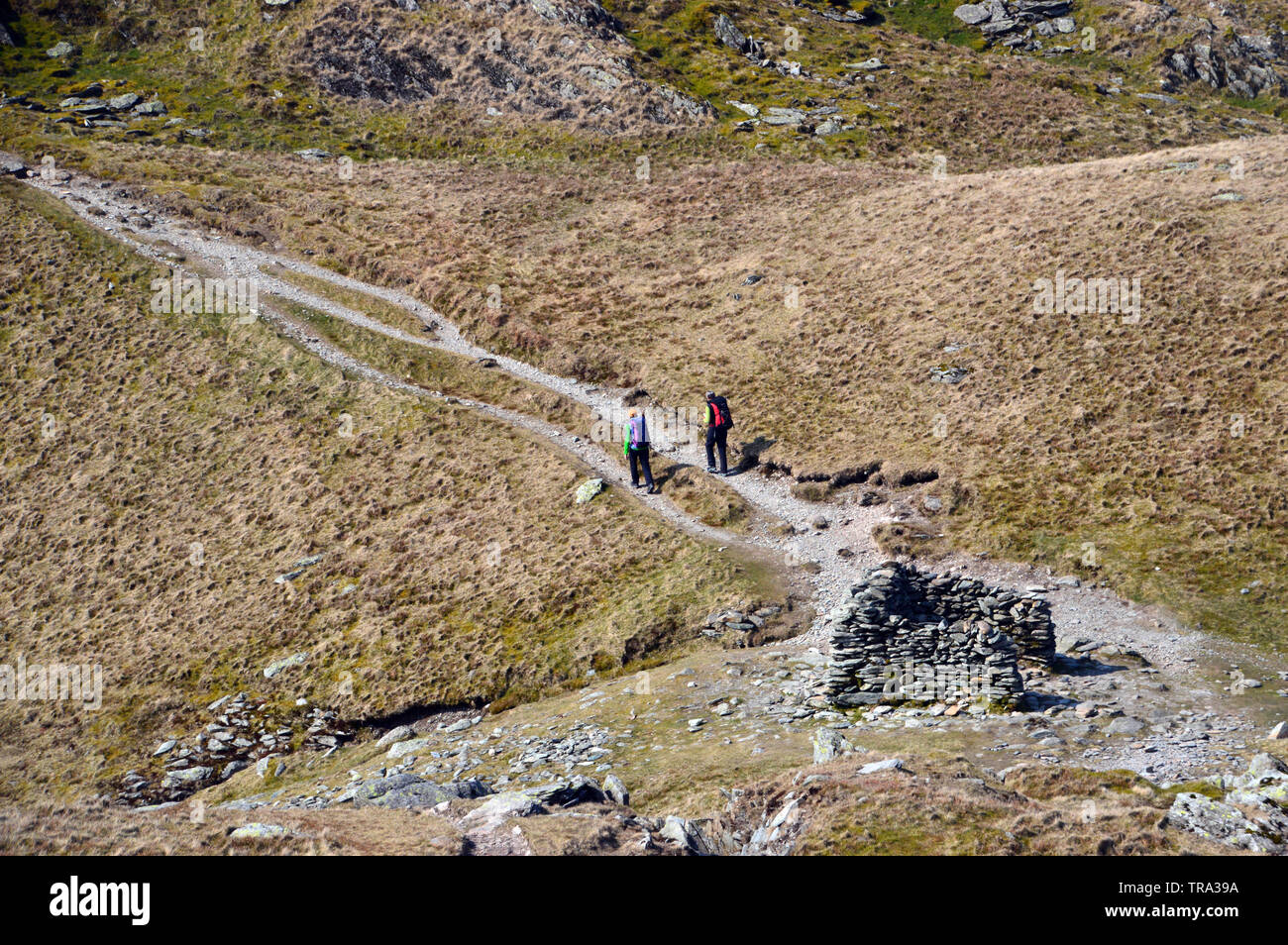 Deux femmes autour de la pierre à l'abri Nan Bield col en direction de la mauvais Mardale Wainwright Bell dans le Parc National du Lake District, Cumbria. Banque D'Images