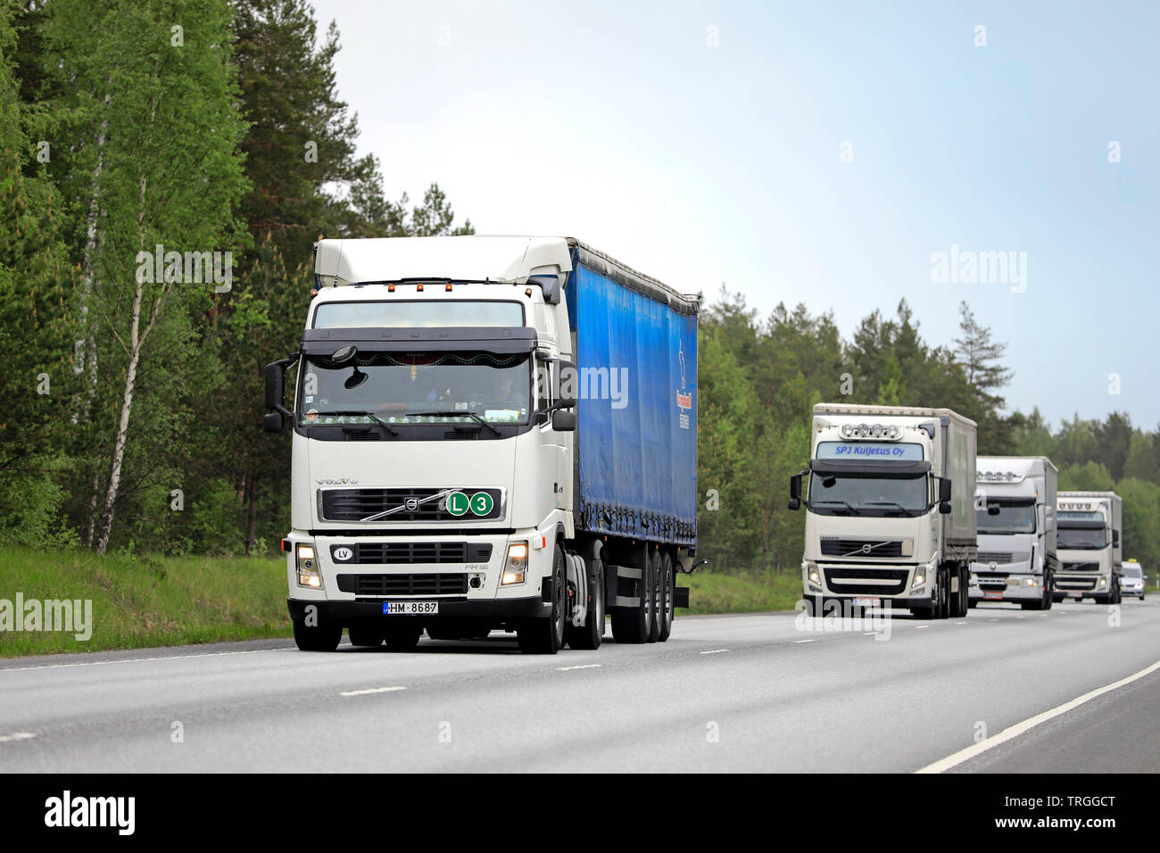 Raasepori, Finlande. Le 24 mai 2019. Flotte de camions de marchandises blanc, Volvo FH et Renault Premium, de la circulation routière sur une journée nuageuse de printemps en Finlande Banque D'Images