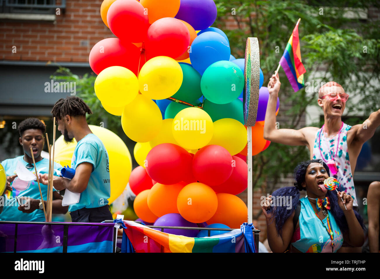 NEW YORK - 25 JUIN 2017 Participants : arc-en-ciel de l'onde les drapeaux sur un flotteur avec un ballon arch dans le gay Pride Parade annuelle à Greenwich Village. Banque D'Images