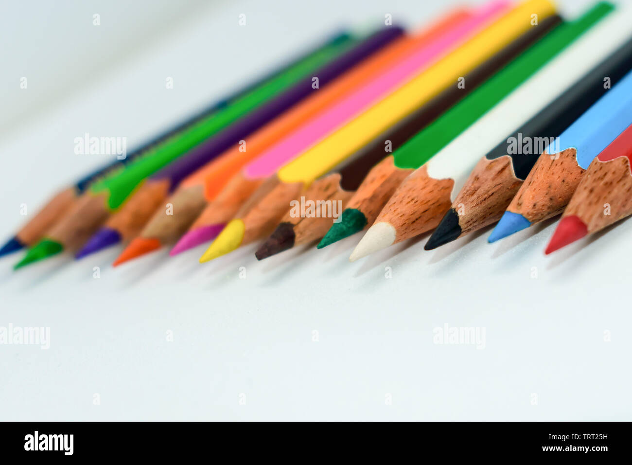 Close-up d'une sélection de crayons, crayons de couleur Multi collent ensemble disposés en une ligne graphique à barres en ligne sur fond blanc, télévision lay. Foc sélective Banque D'Images