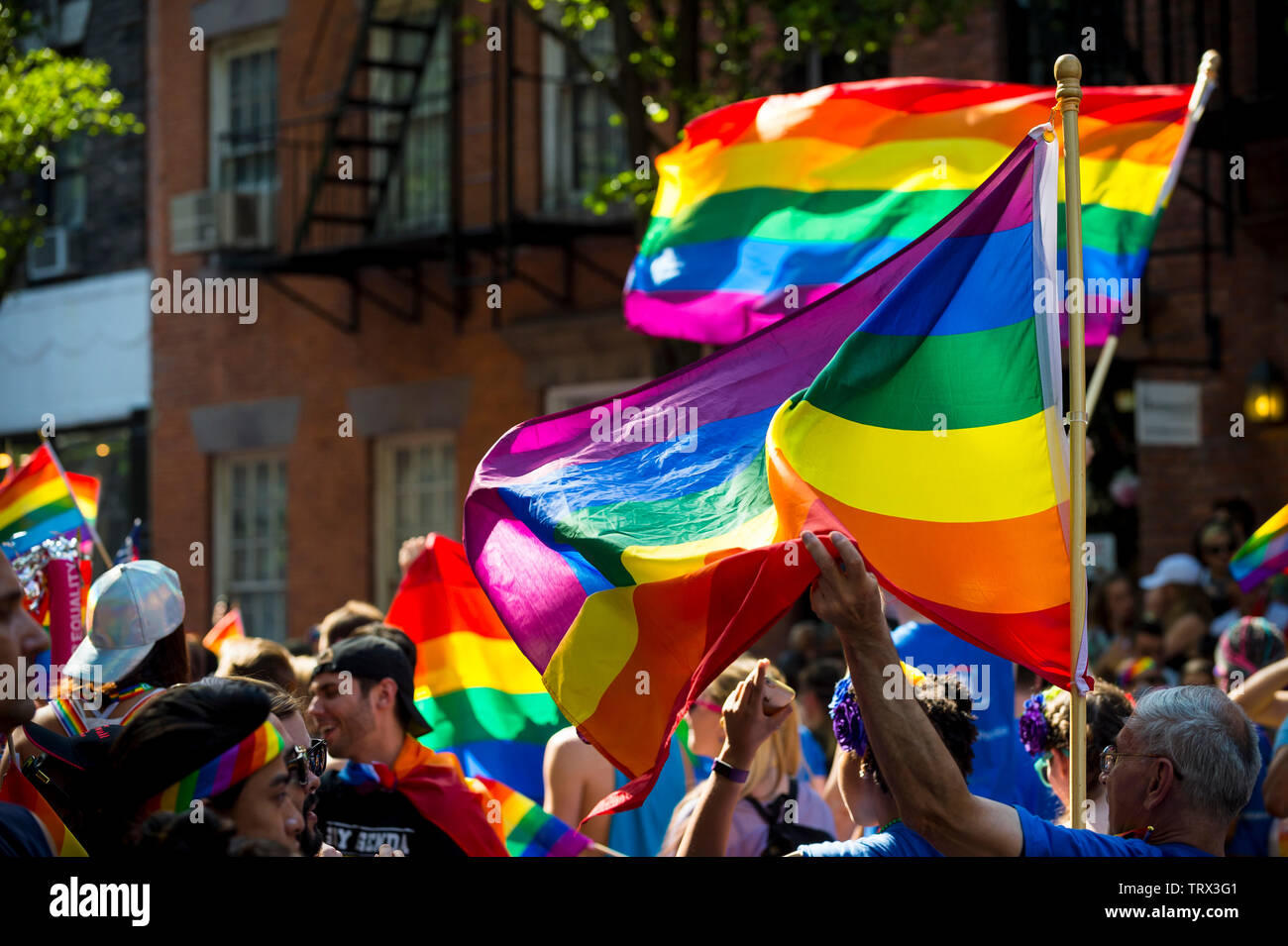 NEW YORK - 25 juin 2017 : vague Supporters drapeaux arc-en-ciel dans la Gay Pride Parade annuelle qui passe par Greenwich Village. Banque D'Images