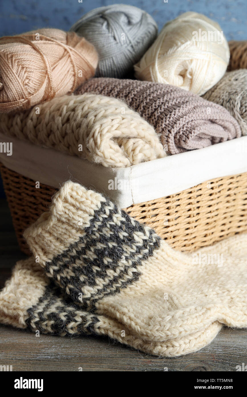 Panier en fil à tricoter et des chaussettes, sur fond de bois Banque D'Images