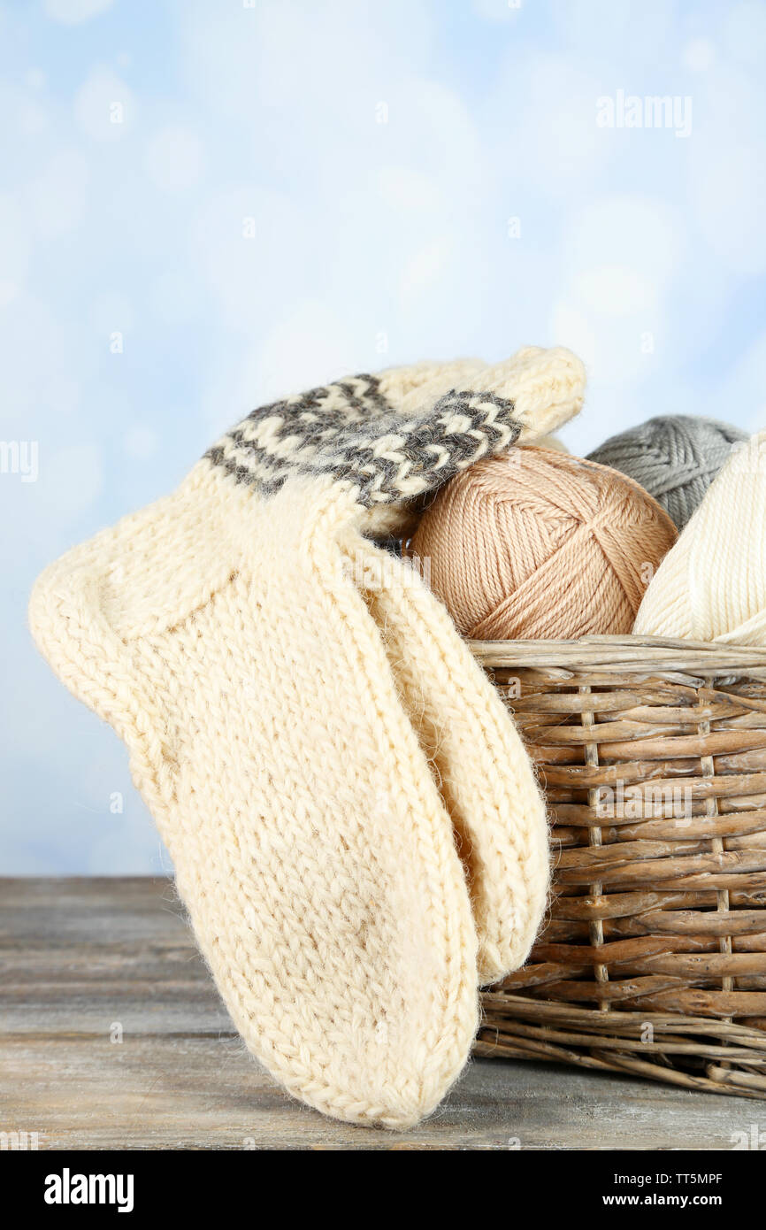 Fil à tricoter et des chaussettes dans le panier, sur un fond clair Banque D'Images