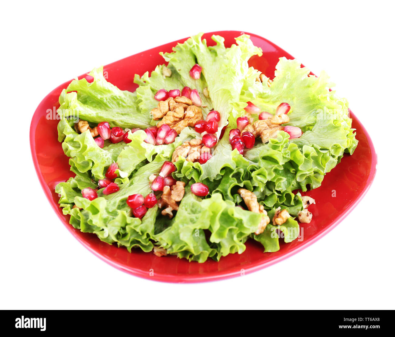 Salade fraîche avec des greens, grenat et d'épices sur la plaque isolated on white Banque D'Images