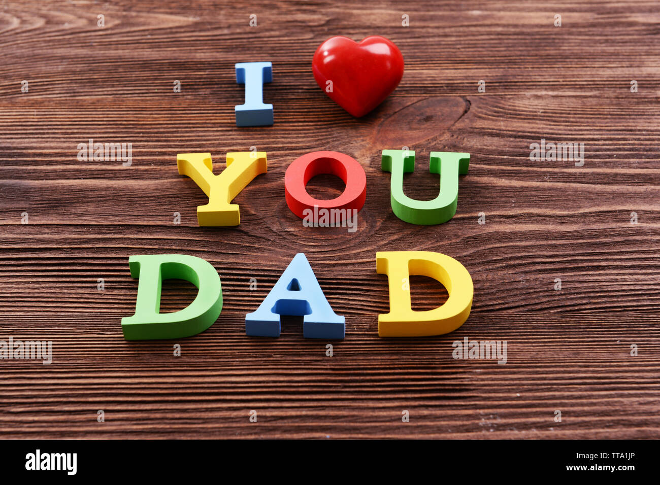 Inscription J'AIME Papa fait de lettres colorées sur fond de bois Banque D'Images