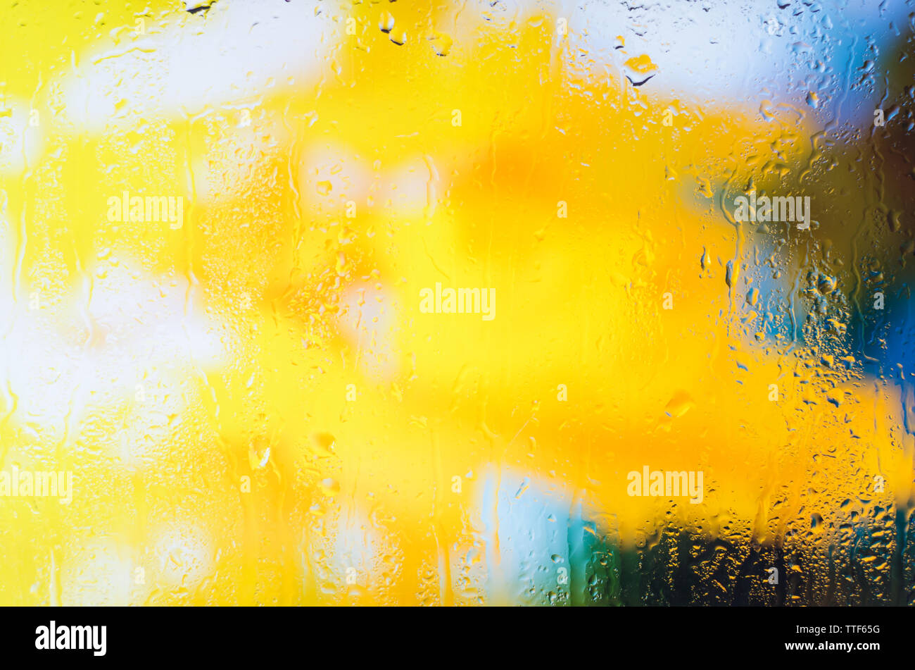 L'automne jaune feuilles d'érable à travers le verre à l'aide de gouttes Banque D'Images