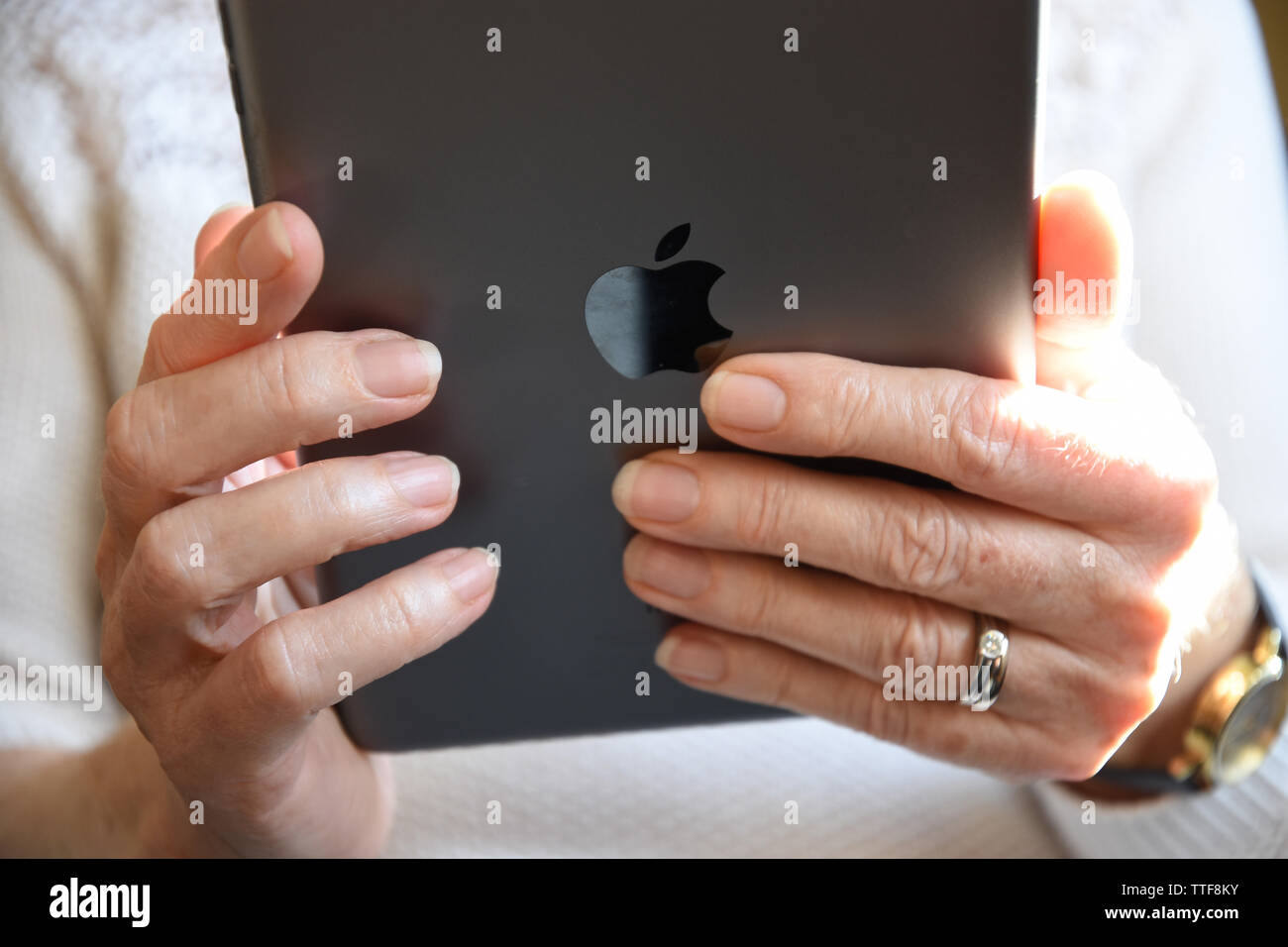 Close up of a senior woman holding an Apple iPad mini. Banque D'Images