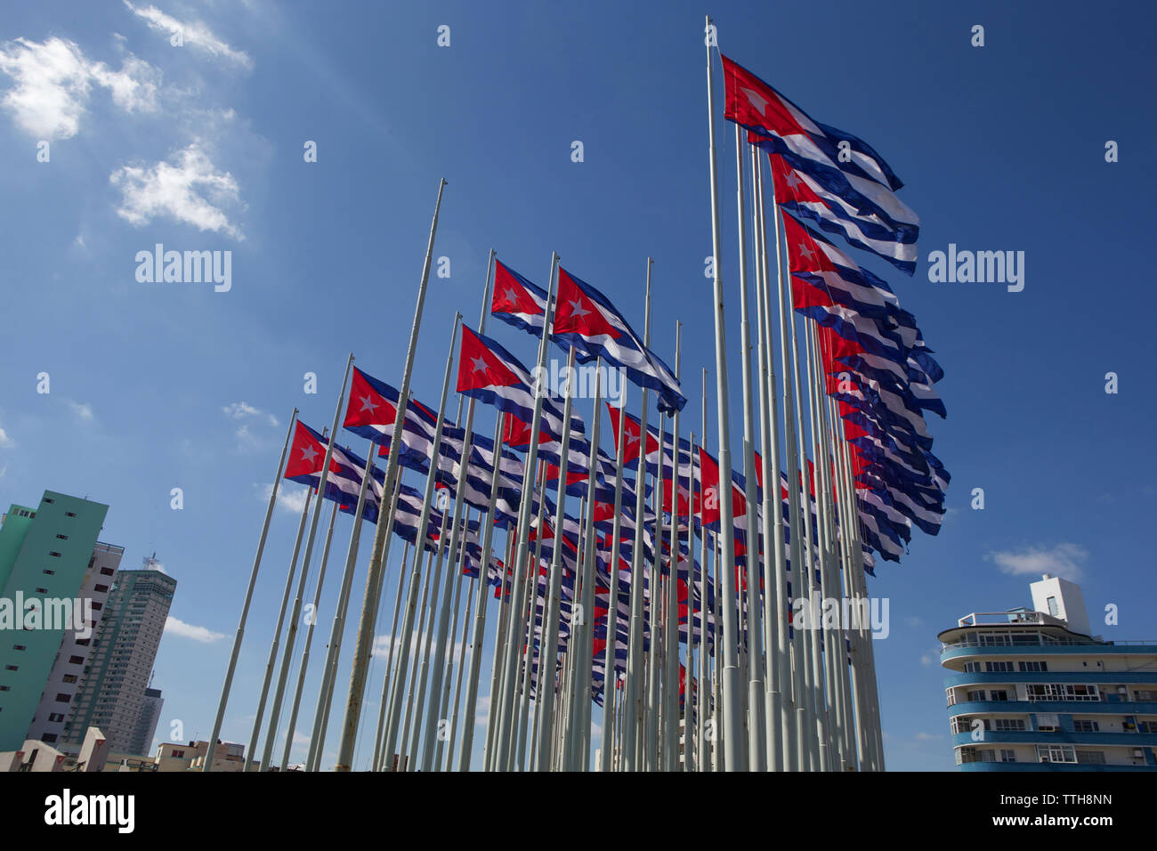 Low angle view of Cuban drapeaux flottant contre le ciel bleu en ville Banque D'Images