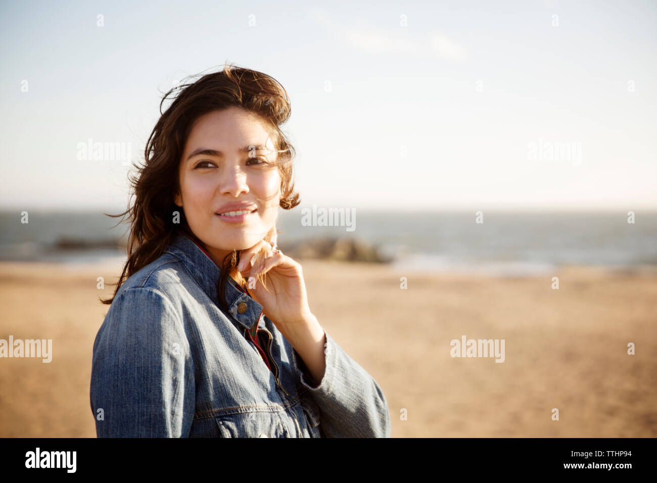 Woman smiling while standing on beach Banque D'Images