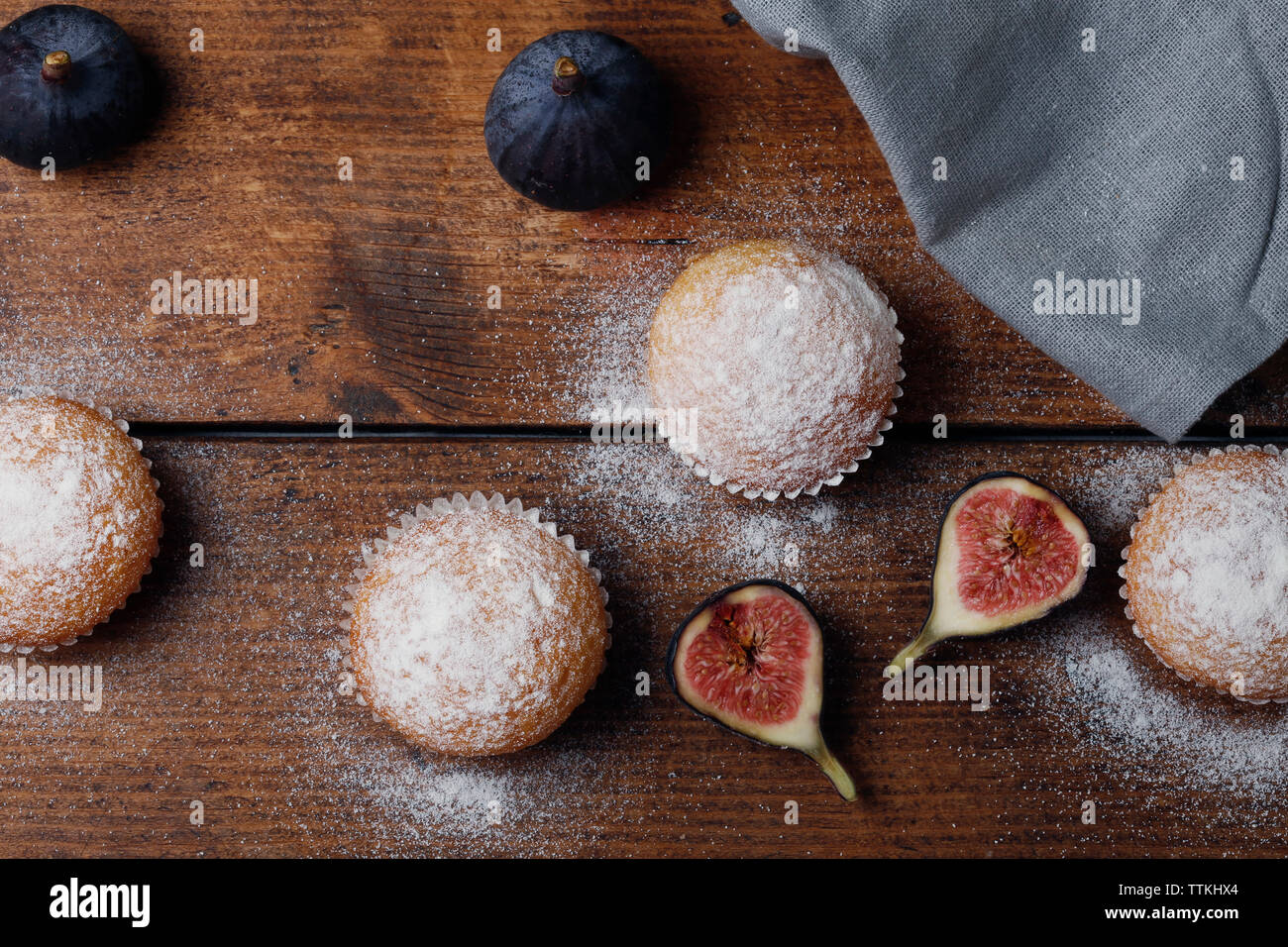 Vue de dessus de muffins aux figues par serviette sur table en bois Banque D'Images