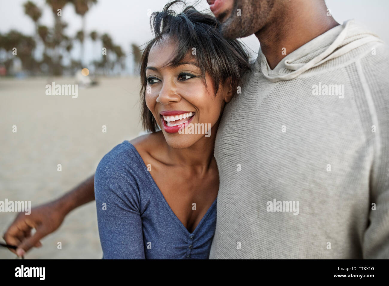 Happy woman embracing man at beach Banque D'Images