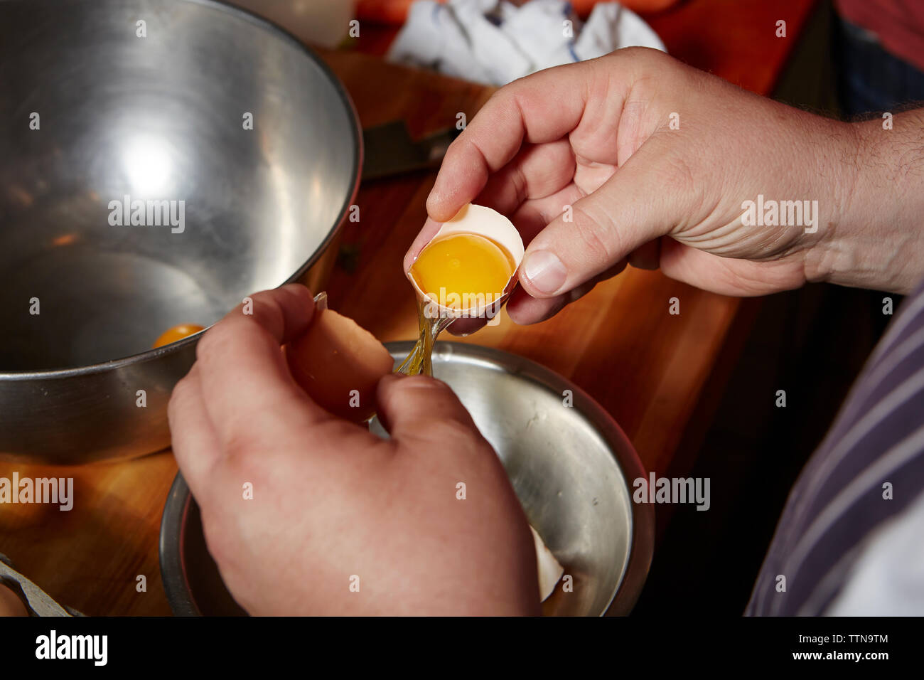 Mid-adult man casser des œufs Banque D'Images