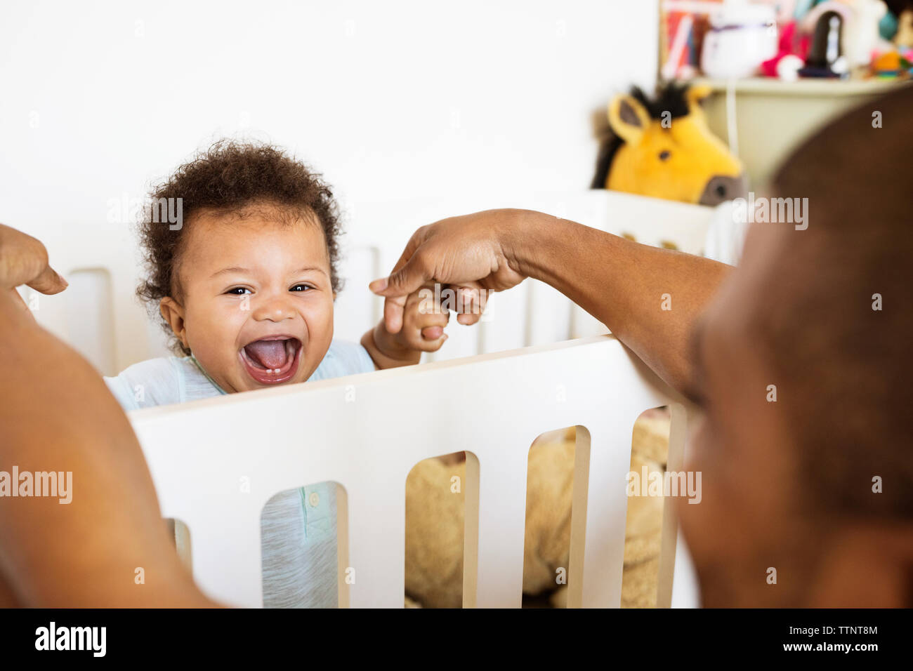 Portrait of cheerful baby boy playing with father at home Banque D'Images