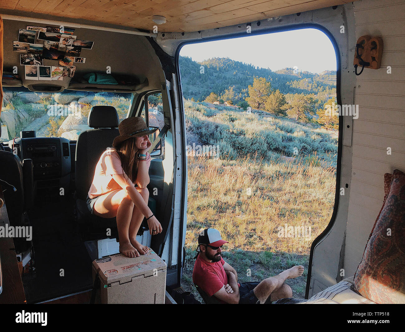 High angle view of couple looking at view while sitting in motor home à forest Banque D'Images