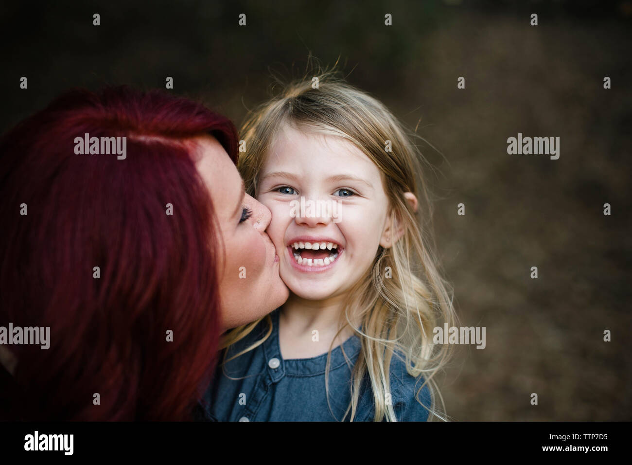 Portrait de fille joyeuse avec la mère de l'embrasser Banque D'Images