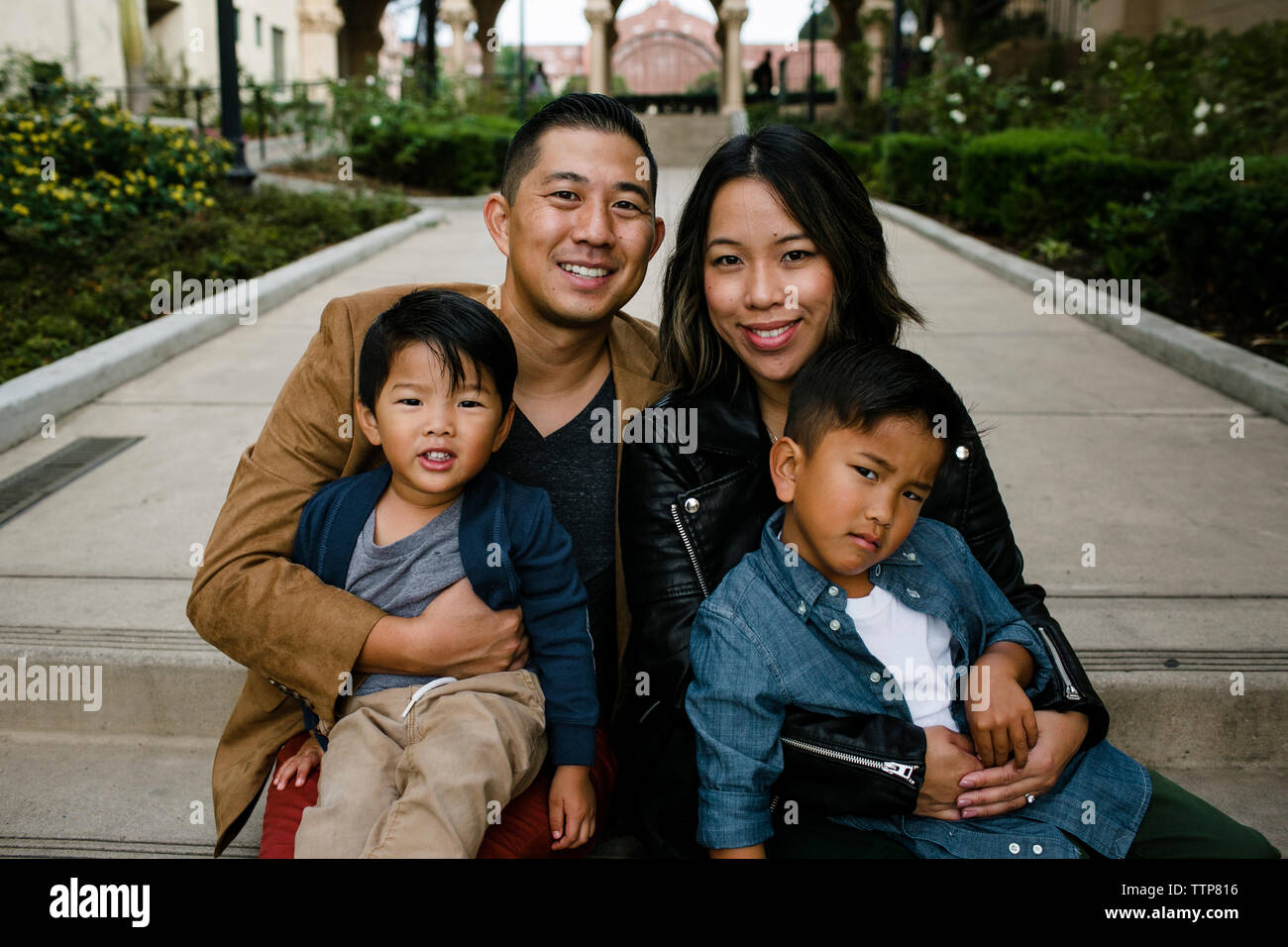 Portrait of smiling parents avec mignon fils assis sur les marches à Balboa Park Banque D'Images