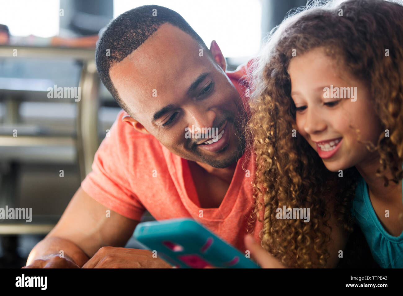 Close-up de père et fille jouer jeu vidéo tout en se trouvant à la maison Banque D'Images
