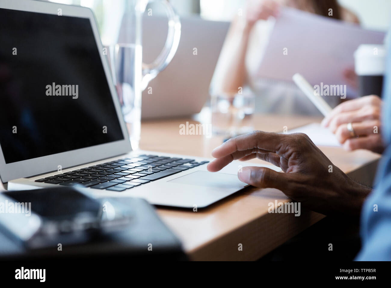 Portrait of businessman using laptop in office Banque D'Images