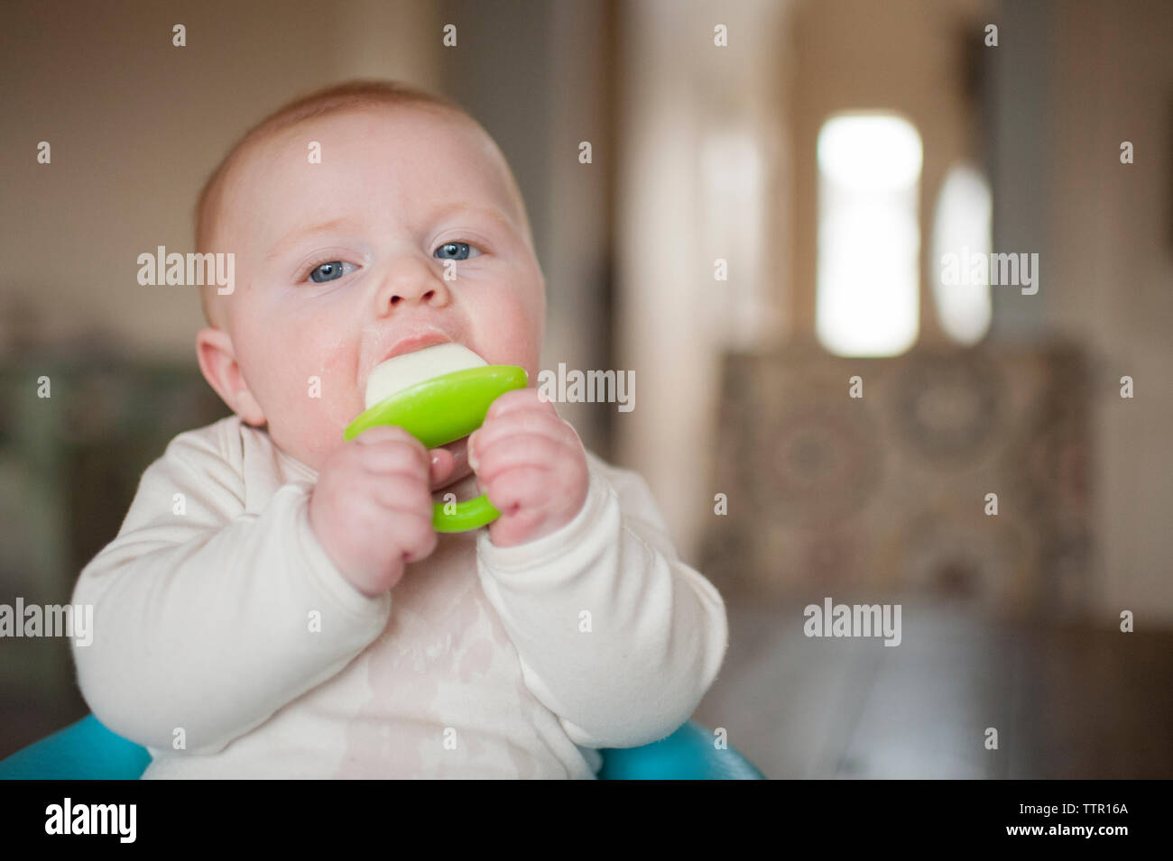 Portrait of baby boy playing with pacifier Banque D'Images