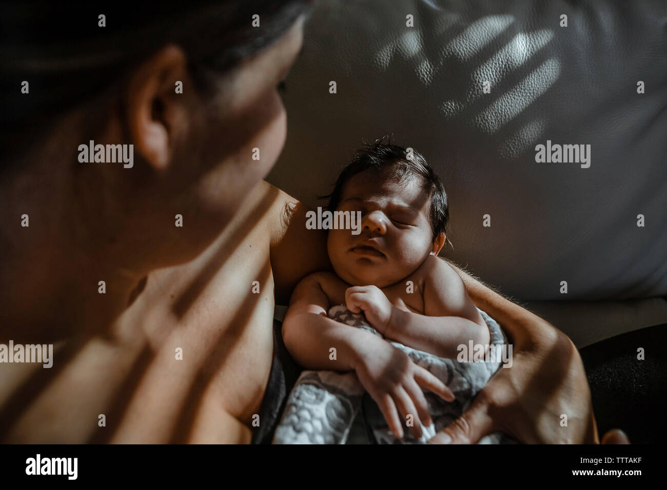 Vue de dessus de mère portant nouveau-né fille dormir à la maison Banque D'Images