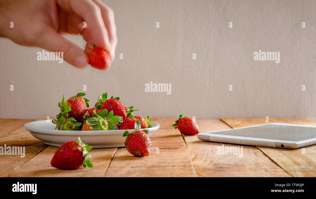 Fruits rouges fraises sur table en bois avec copie espace pour le texte. L'alimentation saine simple concept. Banque D'Images