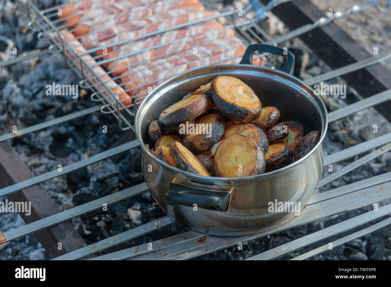 Préparer les pommes dans une casserole à fond de la viande crue enfilés en brochettes sur un grill Banque D'Images