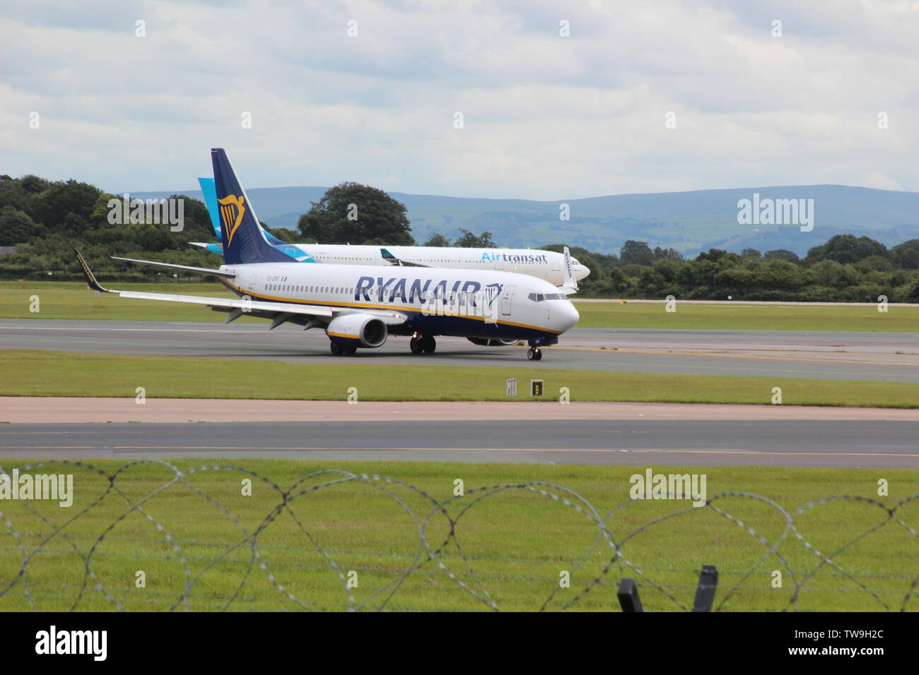Les familles en visite dans la piste de l'aéroport de Manchester parc visiteur regardant l'avion aller et venir Banque D'Images