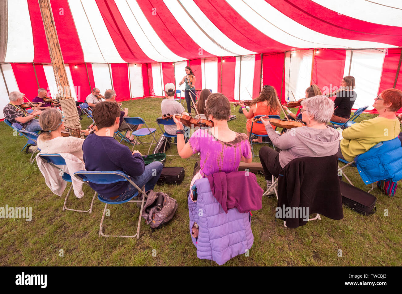 Des ateliers de musique dans un grand chapiteau rayé à la folk music festival. Banque D'Images