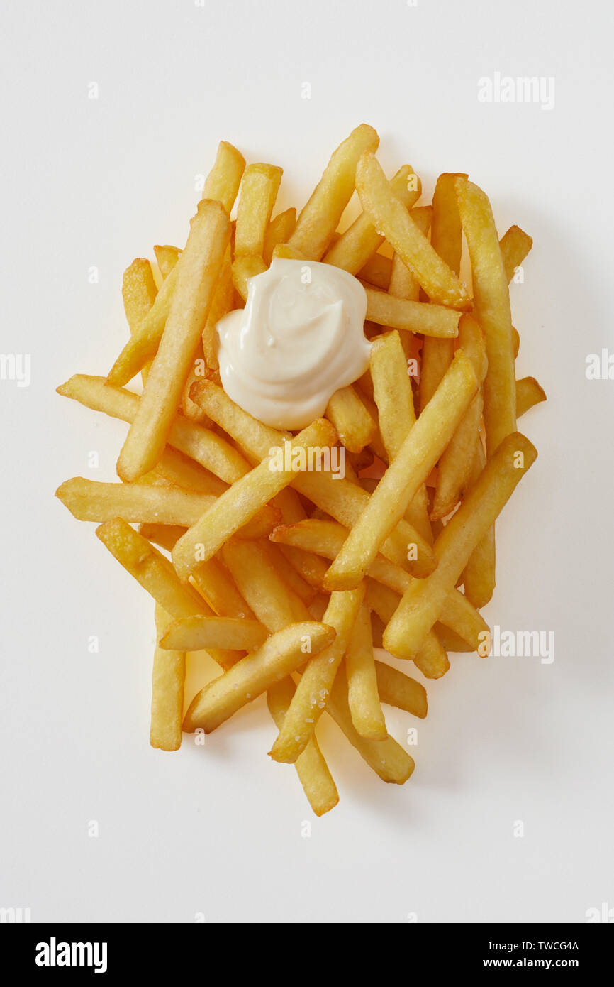 Tasty partie de golden fried chips de pomme de terre , pommes frites ou frites avec mayonnaise de blob ou crème sure Vue de haut en bas on white Banque D'Images